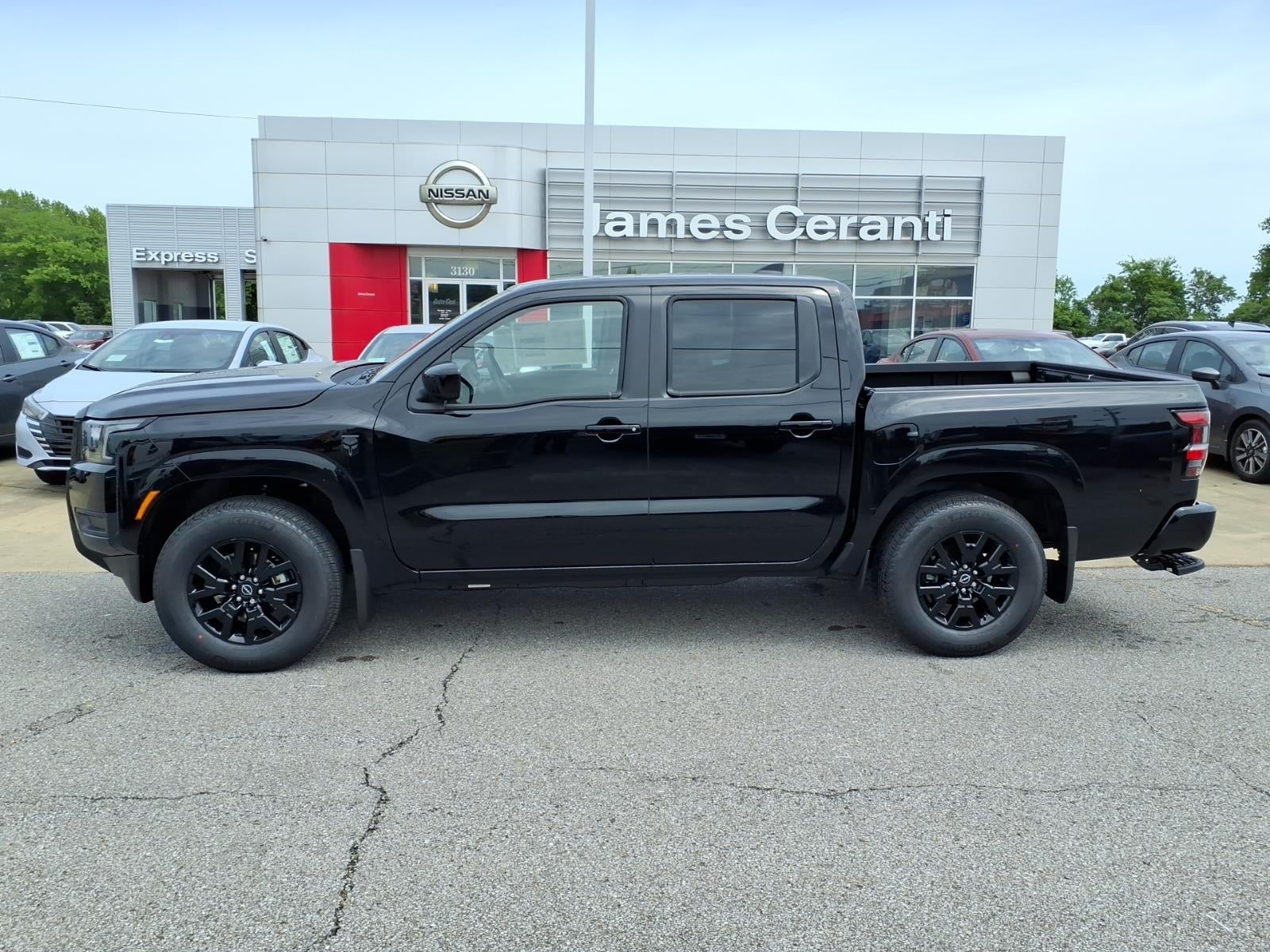 2026 Nissan Frontier Crew Cab SV in Super Black Kh3 — front three-quarter view