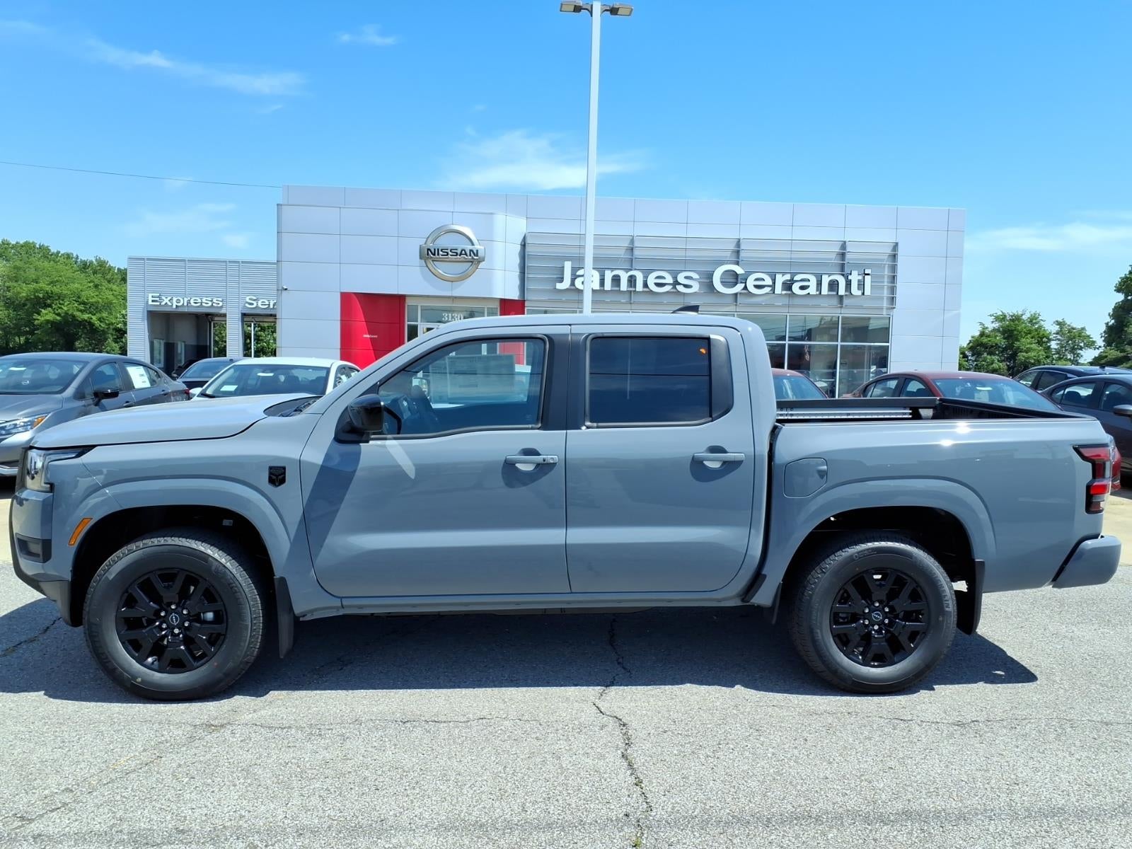 2026 Nissan Frontier Crew Cab SV in Boulder Gray Pearl Kby — front three-quarter view