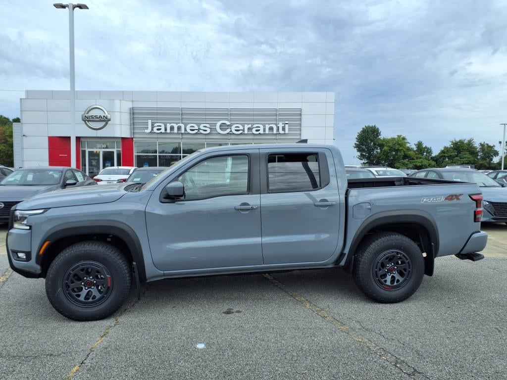 2025 Nissan Frontier Crew Cab PRO-4X in Boulder Gray Pearl Kby — front three-quarter view