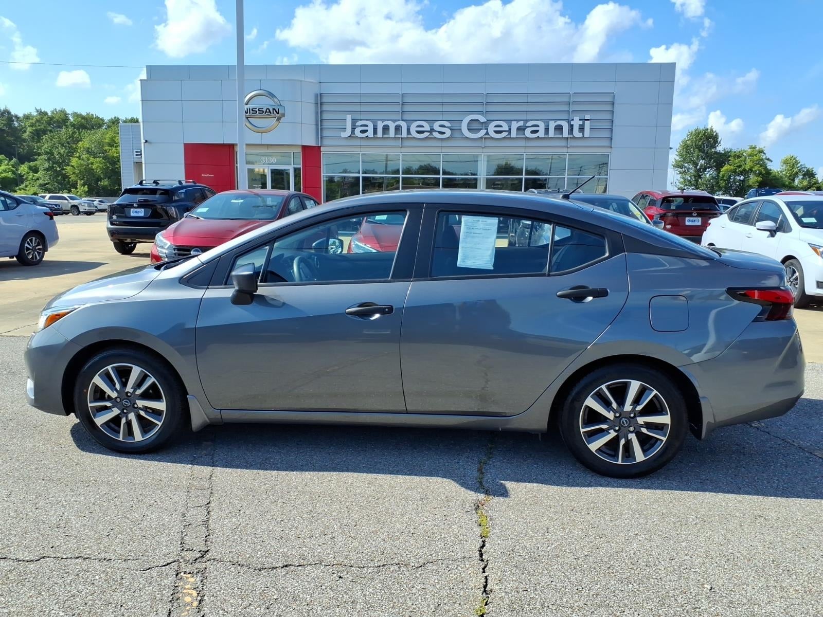 2024 Nissan Versa S in Gun Metallic Kad — front three-quarter view