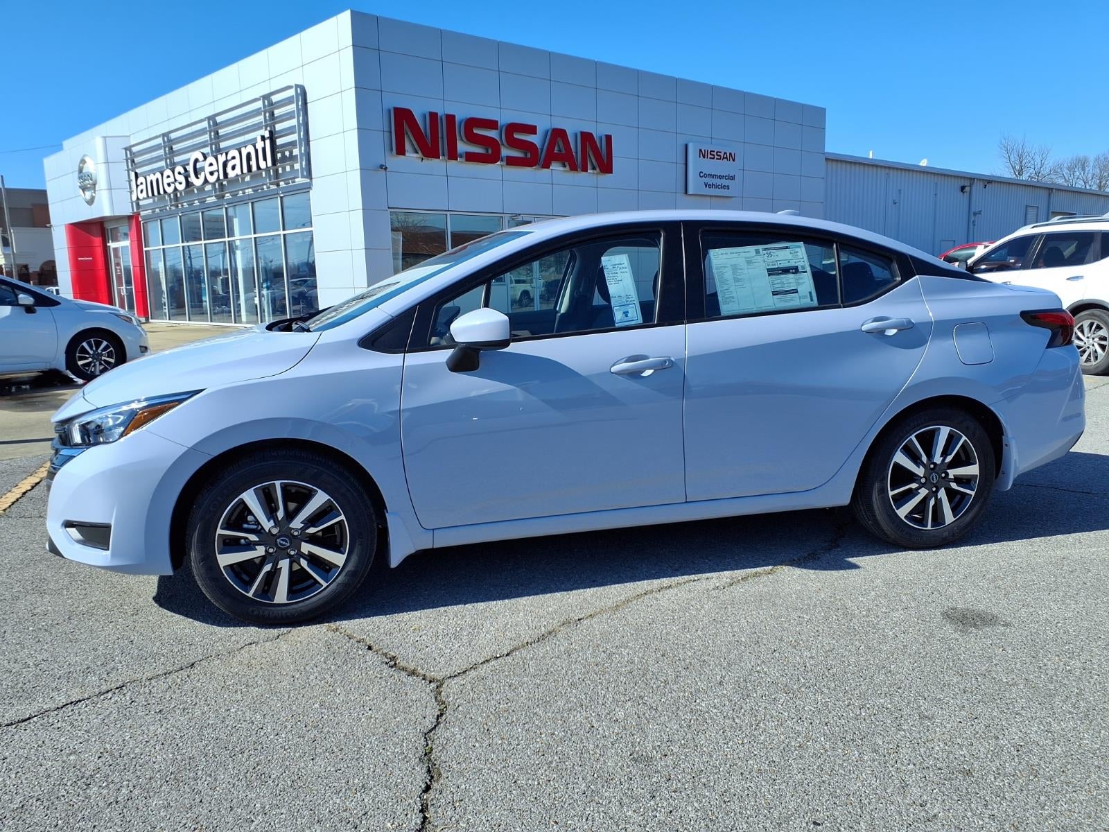 2025 Nissan Versa SV in Gray Sky Pearl Kch — front three-quarter view